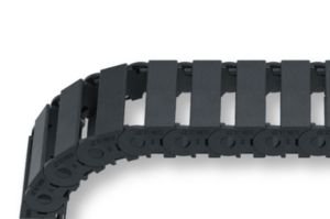 Close-up of a MONO 0180.10 black cable carrier, shown in a curved position and isolated on a white background.